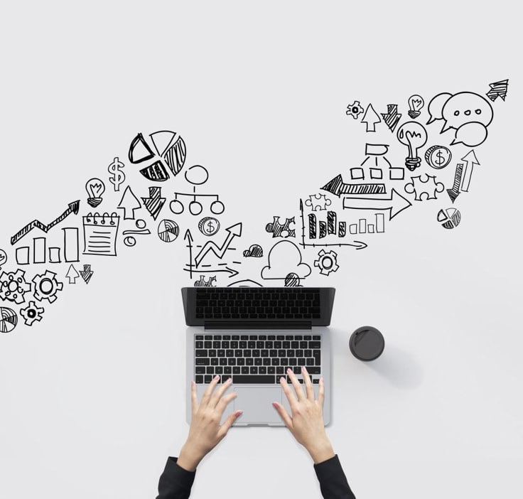 Top-down view of hands typing on a laptop with content marketing strategy sketches flowing from the screen